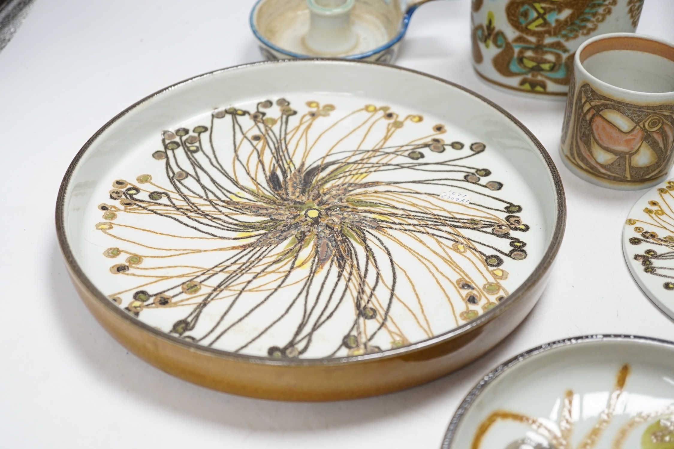 Seven Royal Copenhagen fajance items; a vase decorated with birds, a vase, decorated with fish, a small pot, a holder, two circular dishes and a teapot stand, largest dish 26cm diameter